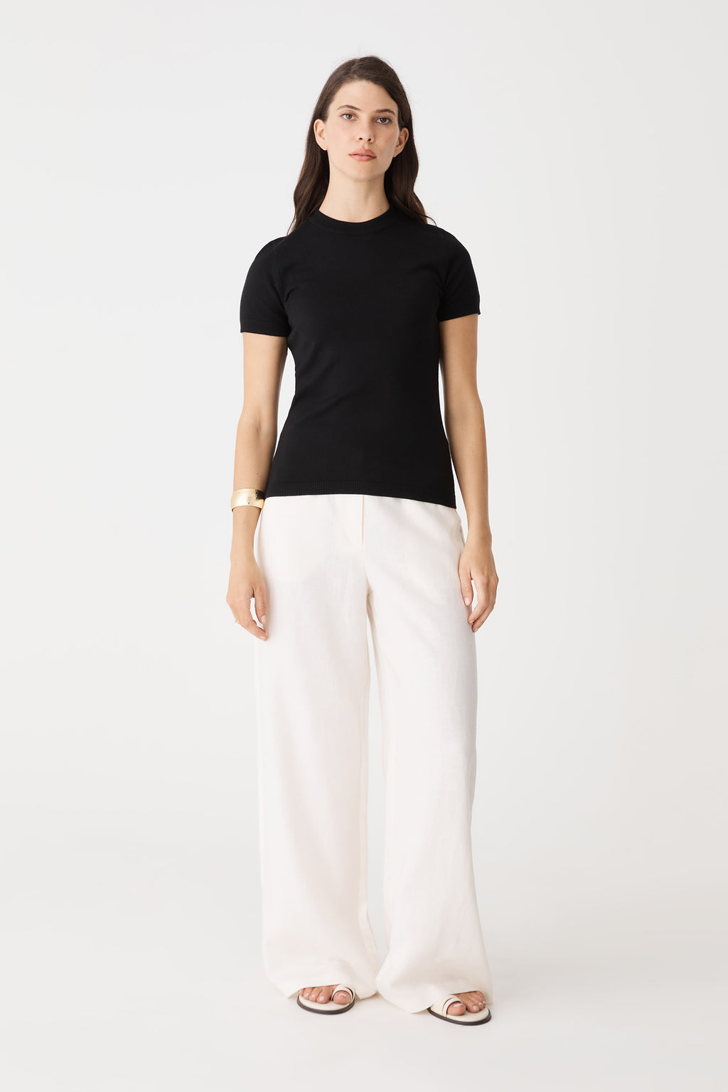 Catherine Short Sleeve Knit in black, front view worn with white wide-leg pants