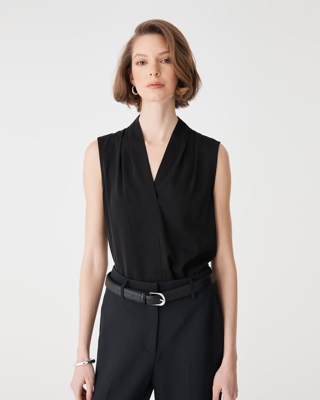 Close-up of the black Alivia 2 V-Neck Top showing the V-neckline and shoulder pleats