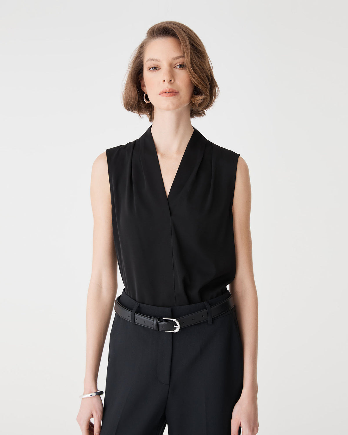 Close-up of the black Alivia 2 V-Neck Top showing the V-neckline and shoulder pleats