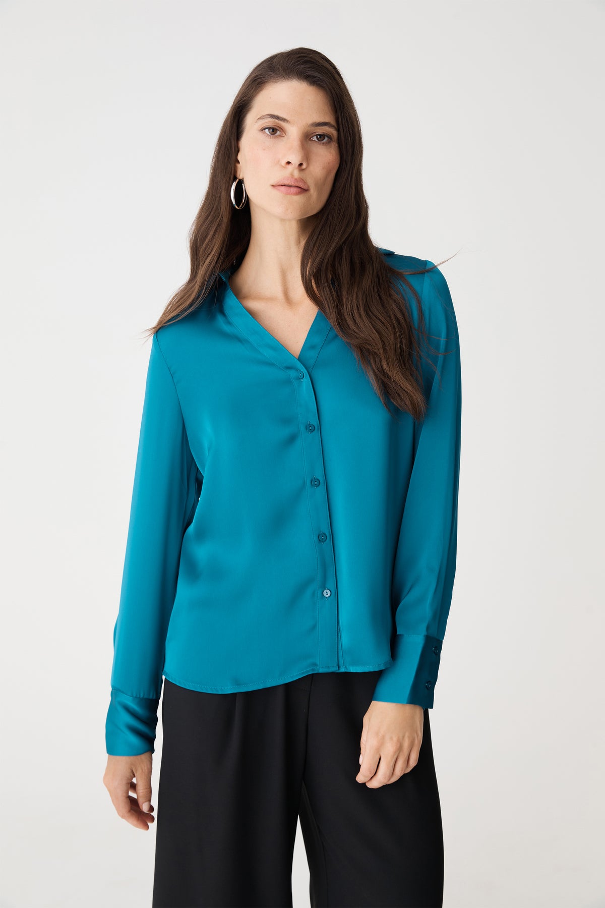 Front close view of the aquamarine blouse showing V-neckline and button front
