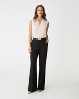 Nikki Flared Leg Pants in black, front view worn with a blush sleeveless top and belt