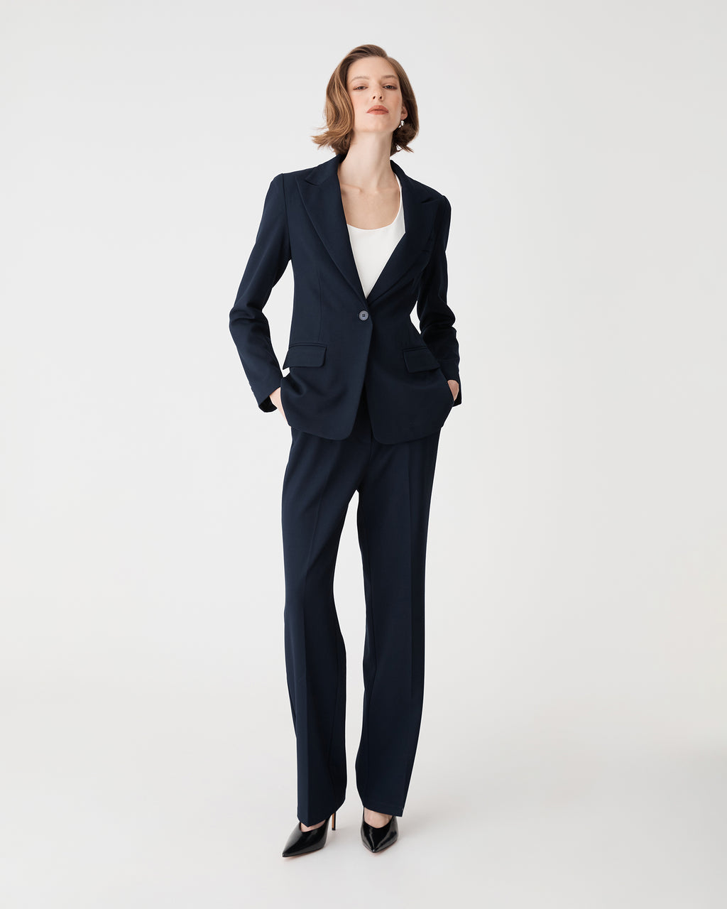 Front view of navy Merid Tailored Pants with straight leg, worn with matching blazer