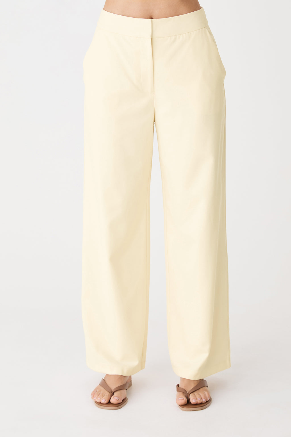 Close-up front view of the butter wide leg pants showing fly zip and side pockets