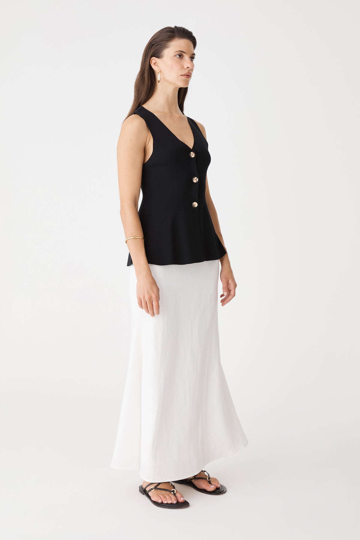 Side view of the ivory Amelia Linen Blend Maxi Skirt with black top