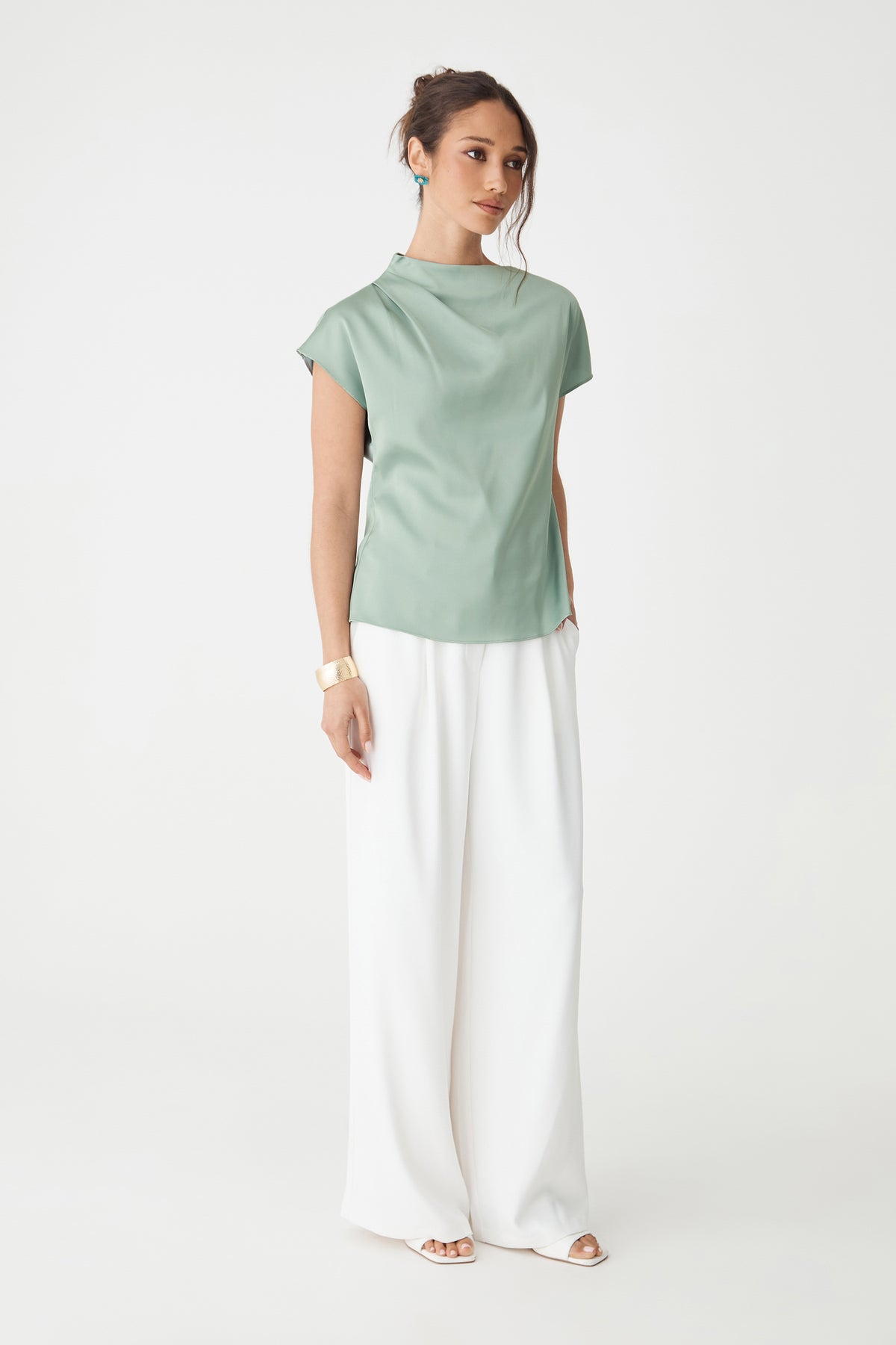 Zafina Pleated Draped Top in spearmint, side-on full-length view worn with white wide-leg trousers