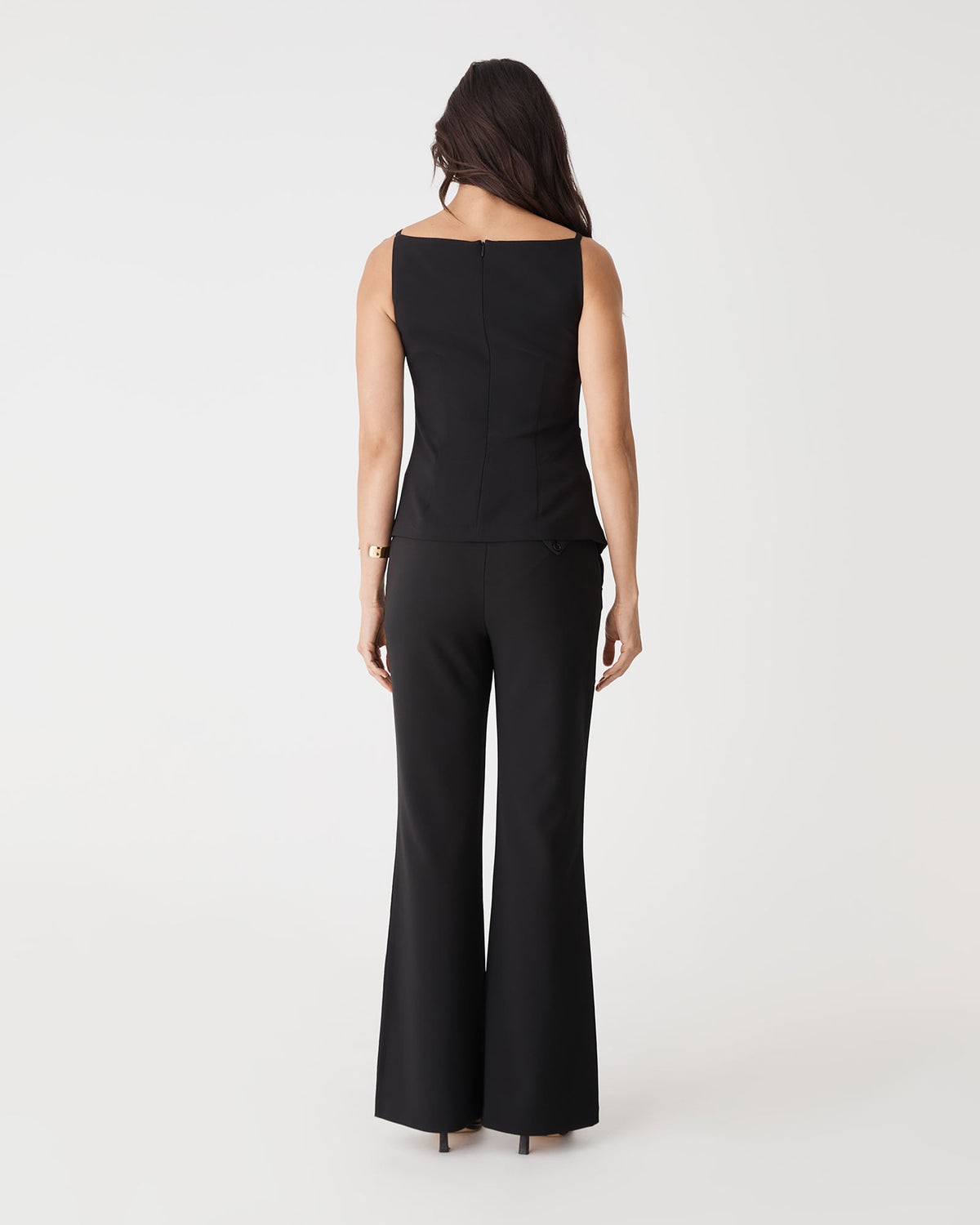 Back view of the black Hannah Apron Top with invisible back zipper