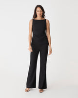 Hannah Apron Top in black, front view worn with matching black bootleg pants