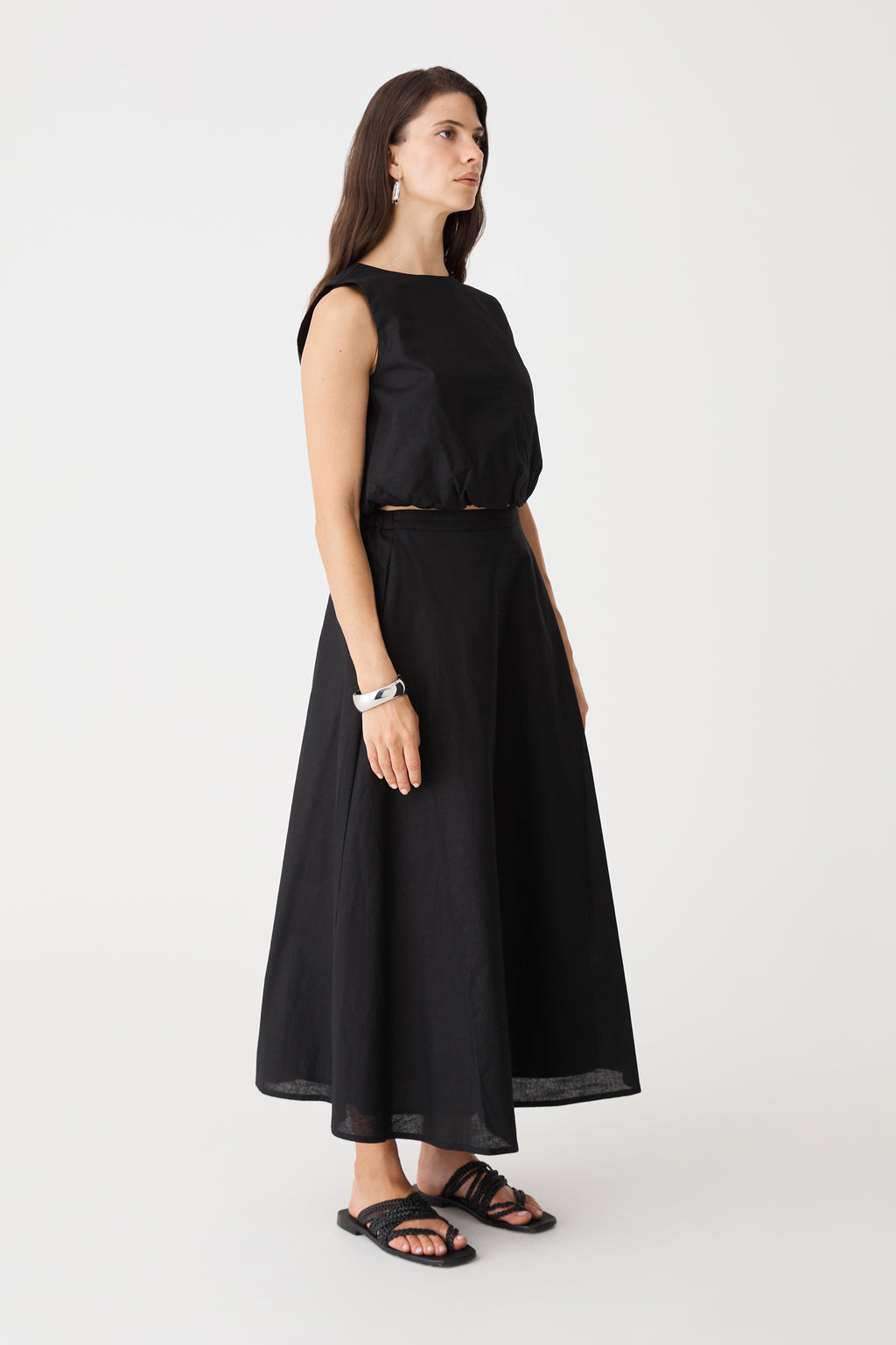 Side view of the black Kenya 2 Ruched Linen Top with matching long skirt