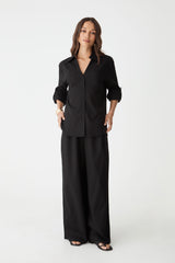 Jazie Tencel Linen Tab Shirt in black, front view worn open-neck with black wide-leg pants
