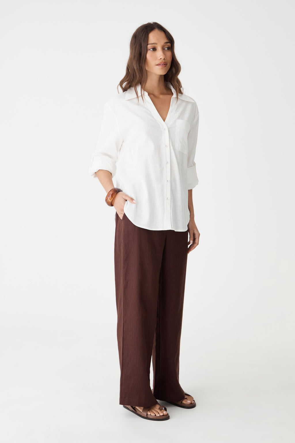 Full-length front view of the ivory Jazie Tencel Linen Tab Shirt with brown wide-leg pants