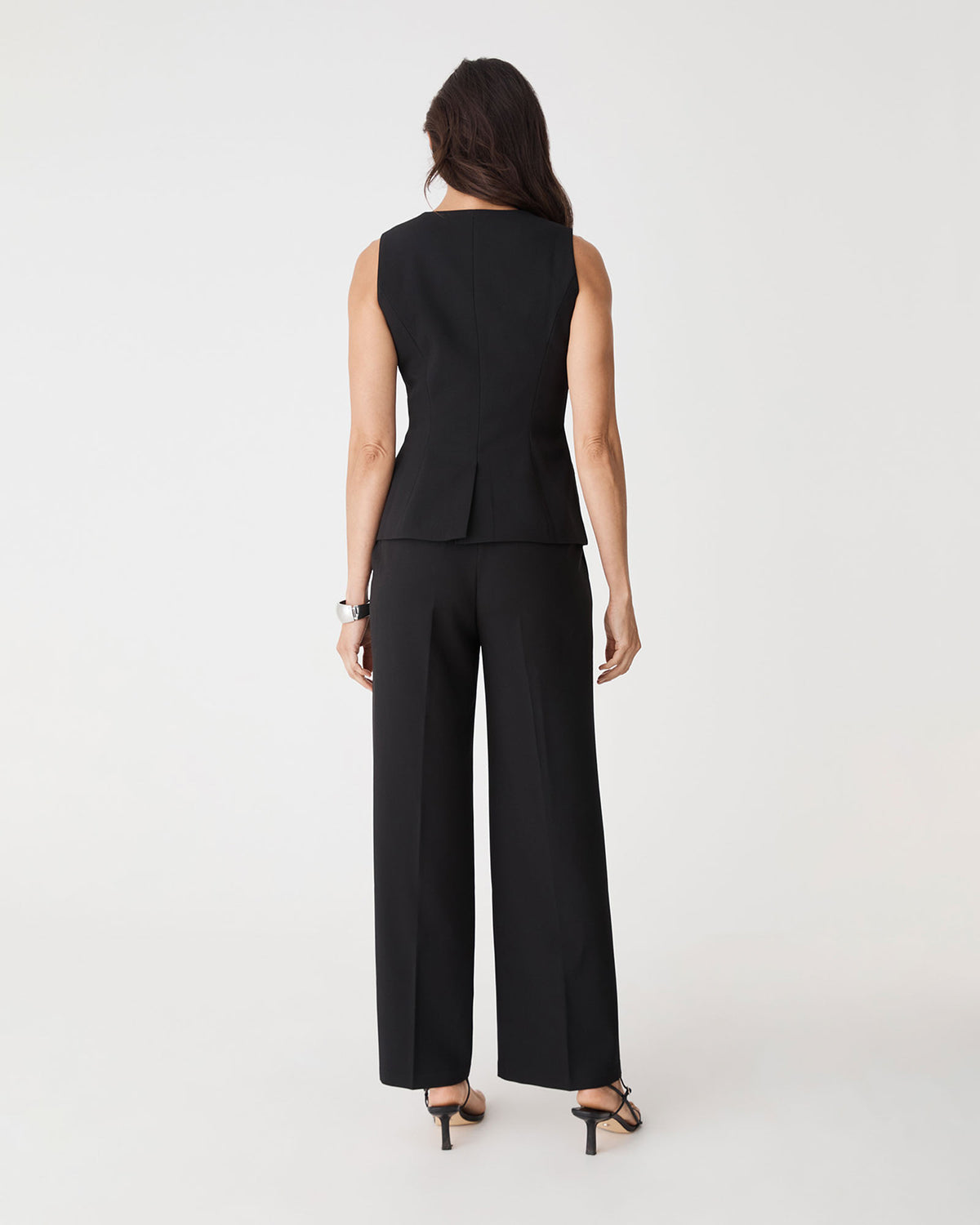 Back view of black Nikki Longline Vest showing single vent