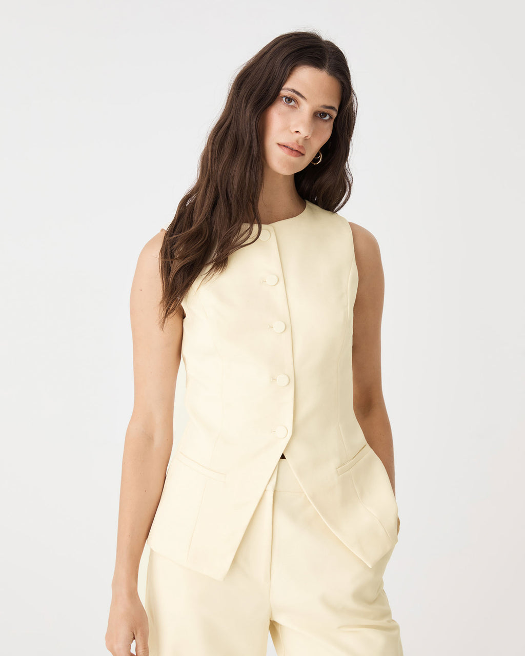 Close-up of the button placket and front welt pocket on the butter vest