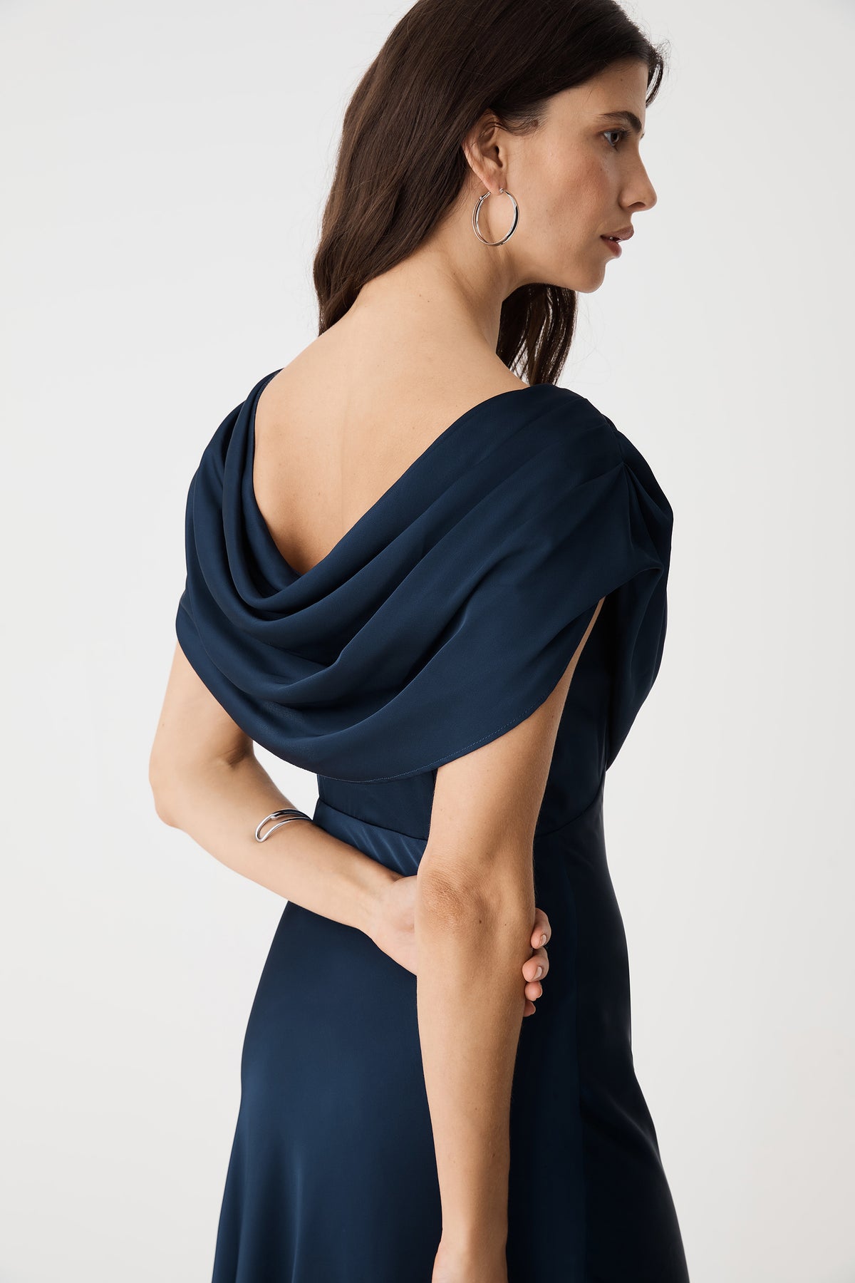 Side-back detail of the low cowl back and shoulder drape in Midnight