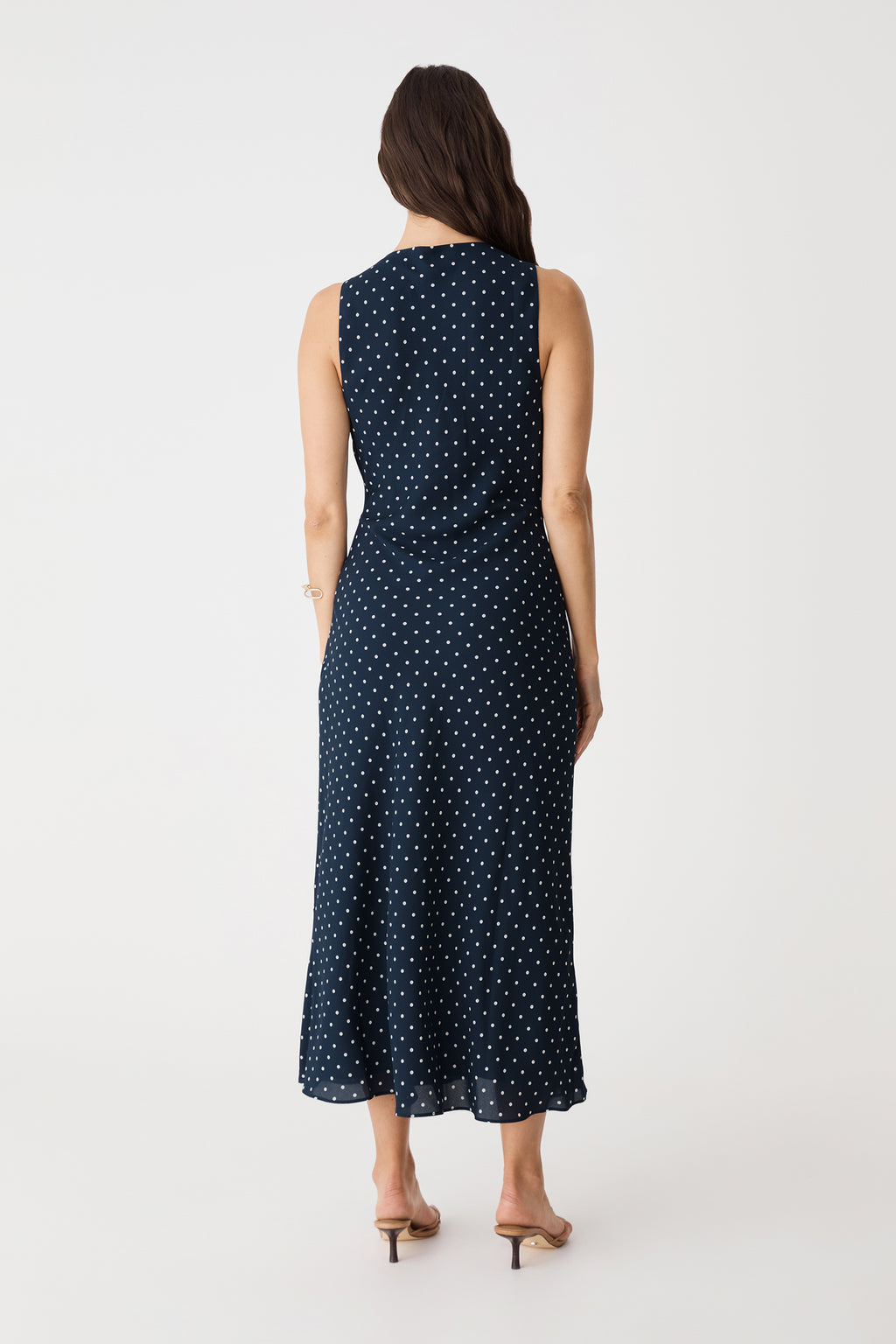 Back view of the navy spot midi dress with full-coverage back