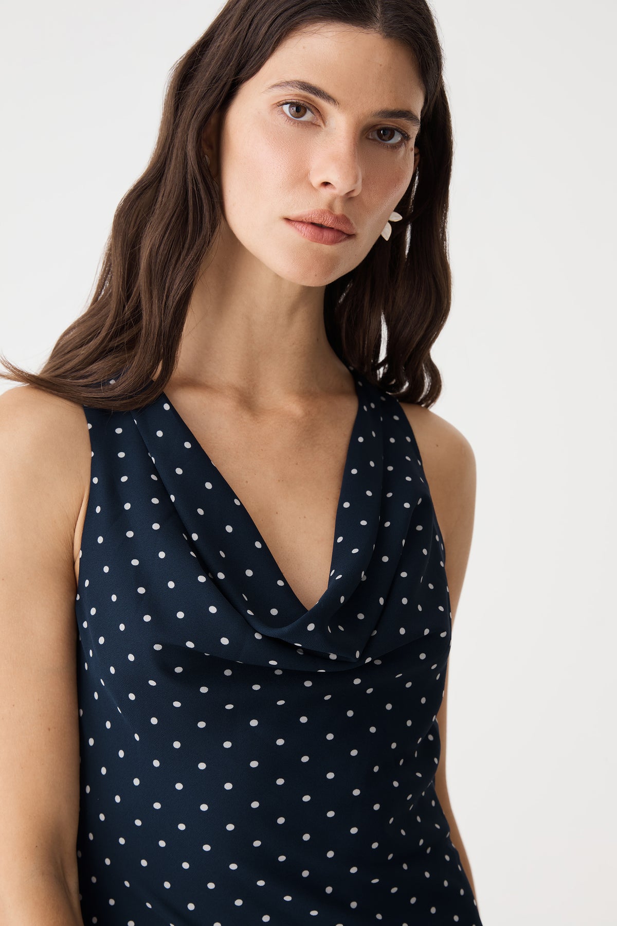 Close-up of the V-shaped cowl neck and polka dot print