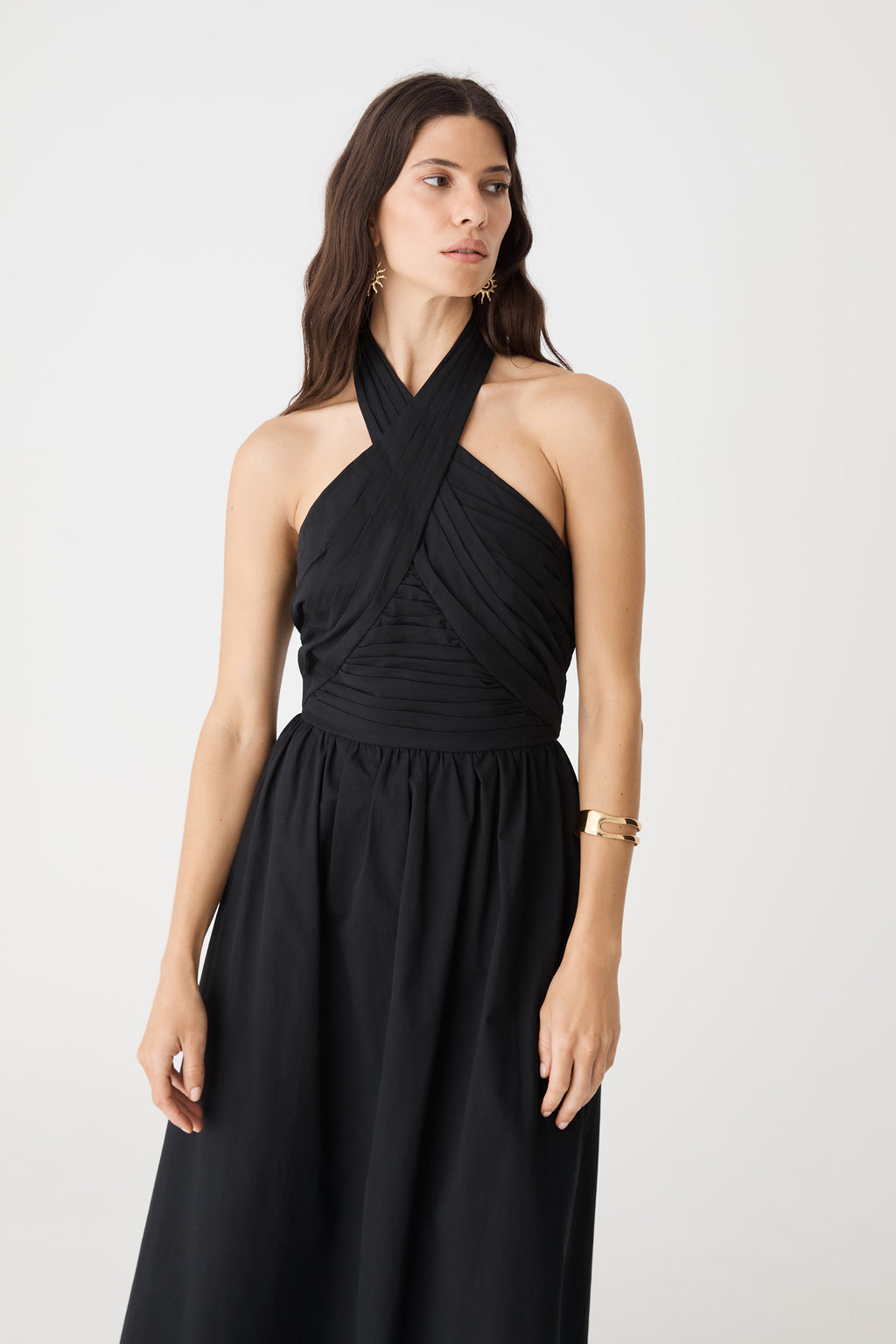 Close-up of the crossover halterneck and pleated bodice in black