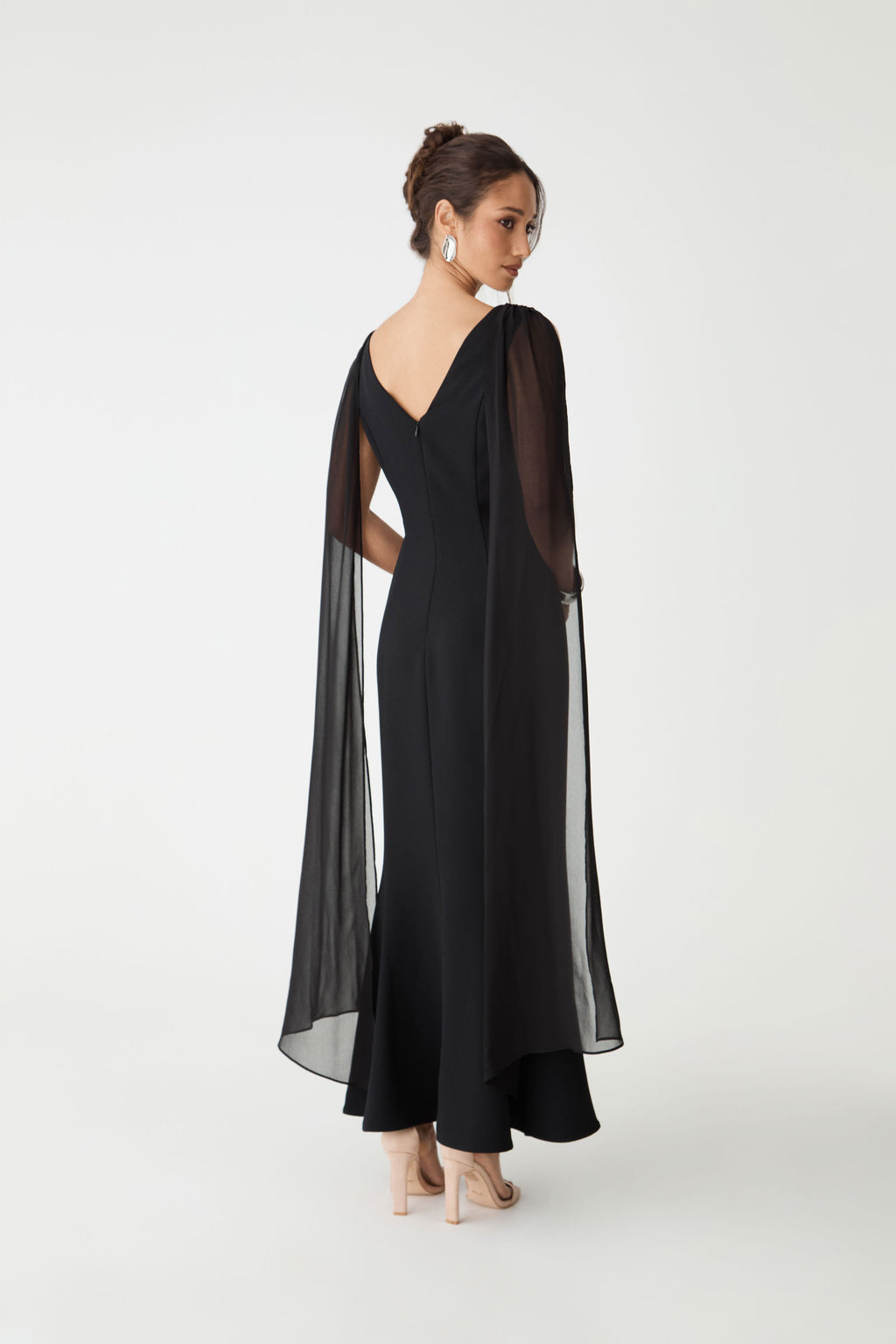 Back view showing the V-neckline, concealed zip and sweeping maxi hem