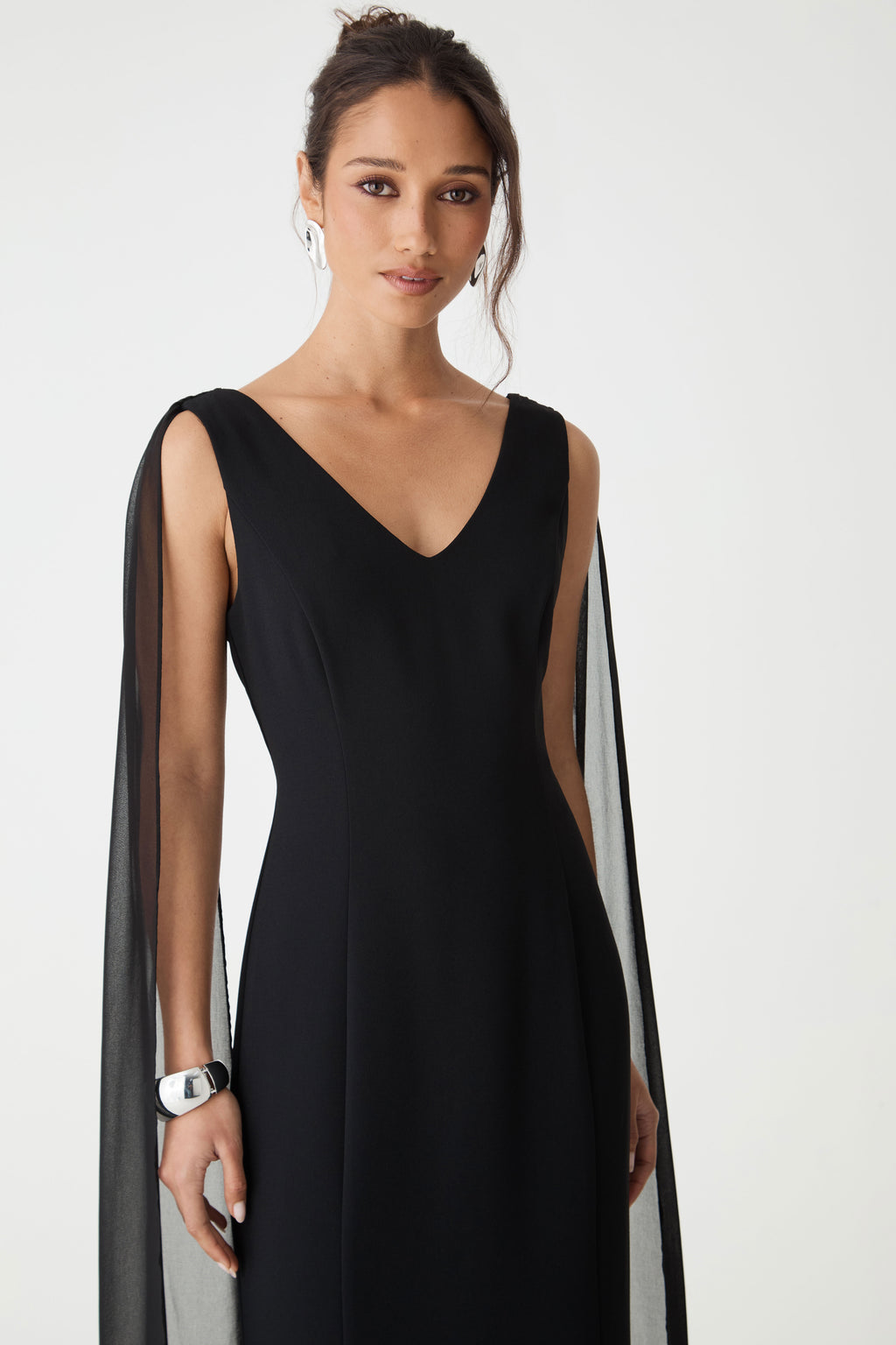 Close-up of the fitted bodice, V-neckline and seam detailing in black