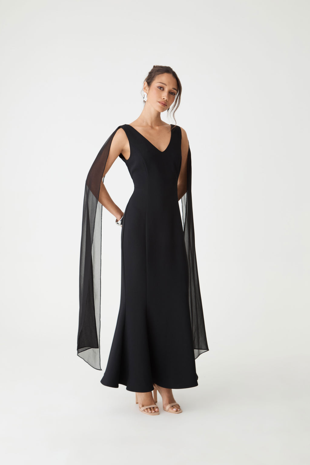 Front view of the black maxi dress showing the mermaid silhouette flaring to the hem