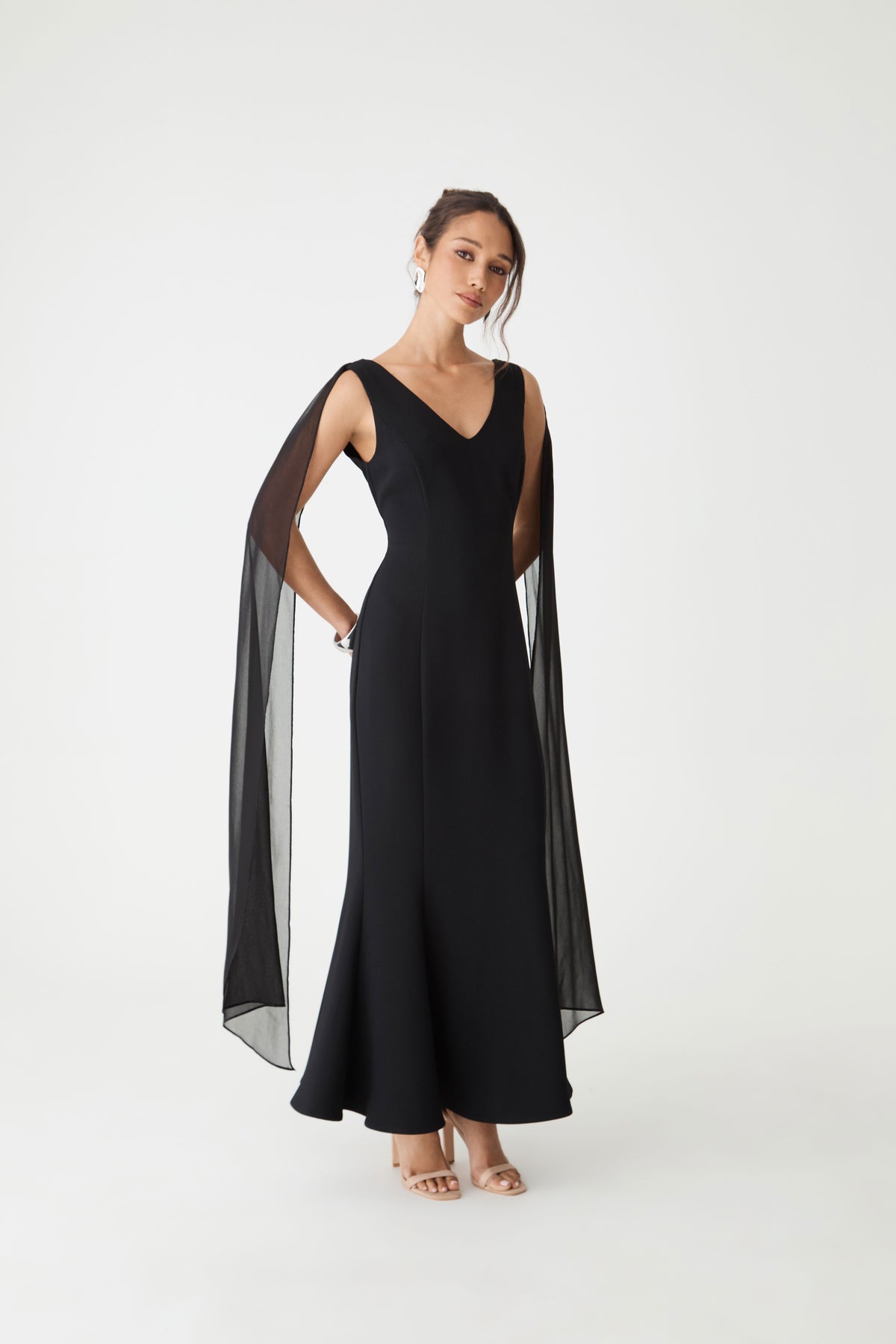 Front view of the black maxi dress showing the mermaid silhouette flaring to the hem