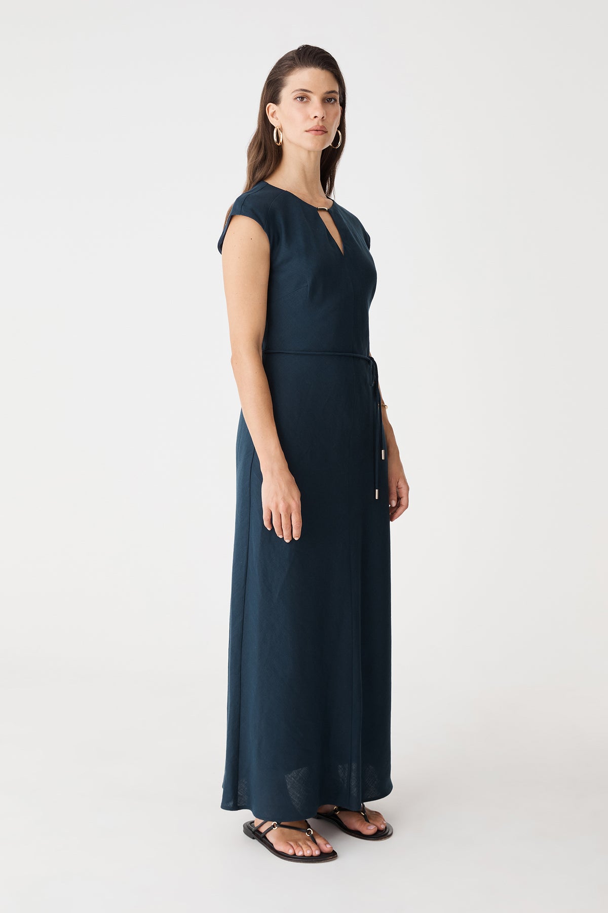 Side view of the navy maxi dress showing the flared skirt