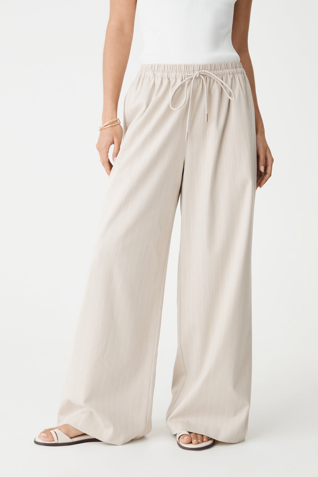 Close-up front view of the drawstring elasticated waistband and wide legs