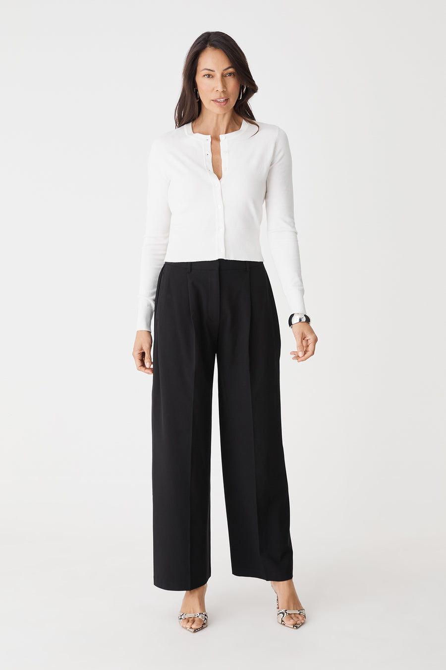 Front view of black Margot Pleated Pants, high-rise wide-leg, worn with a white shirt