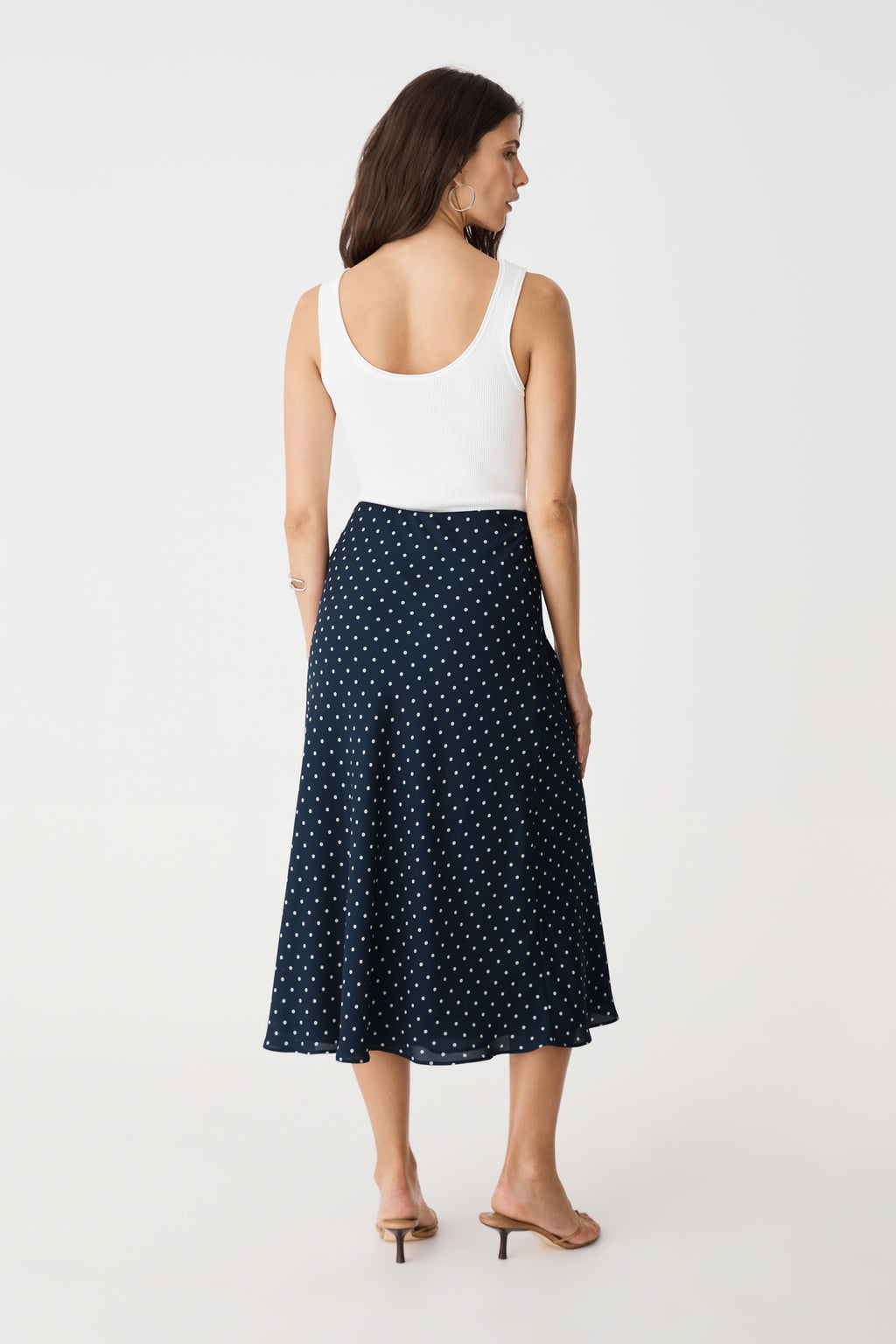 Back view of the navy spot A-line bias skirt with white tank top