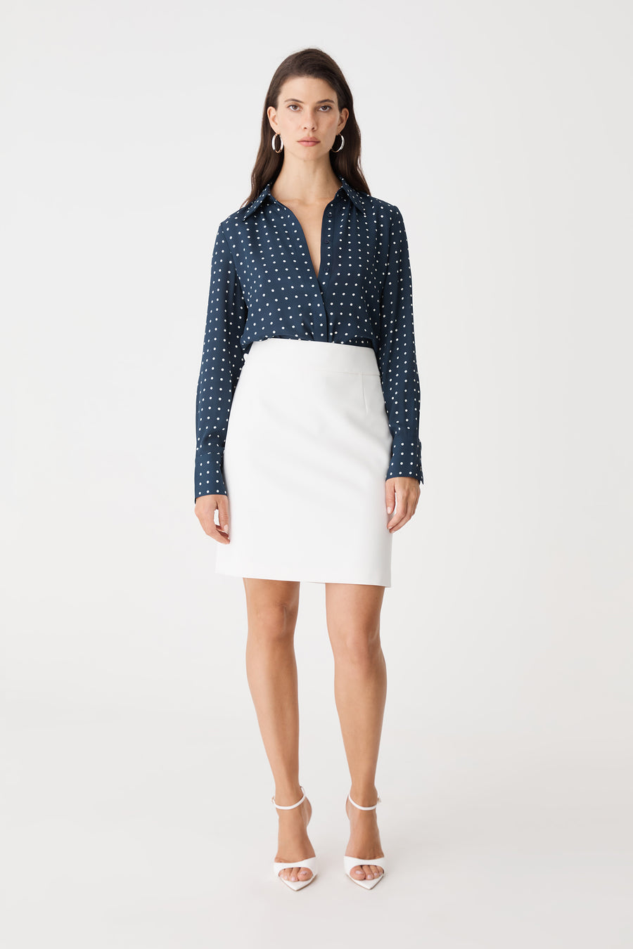 Lydia Short Straight Skirt in white, front view, worn with a navy spotted shirt and heels