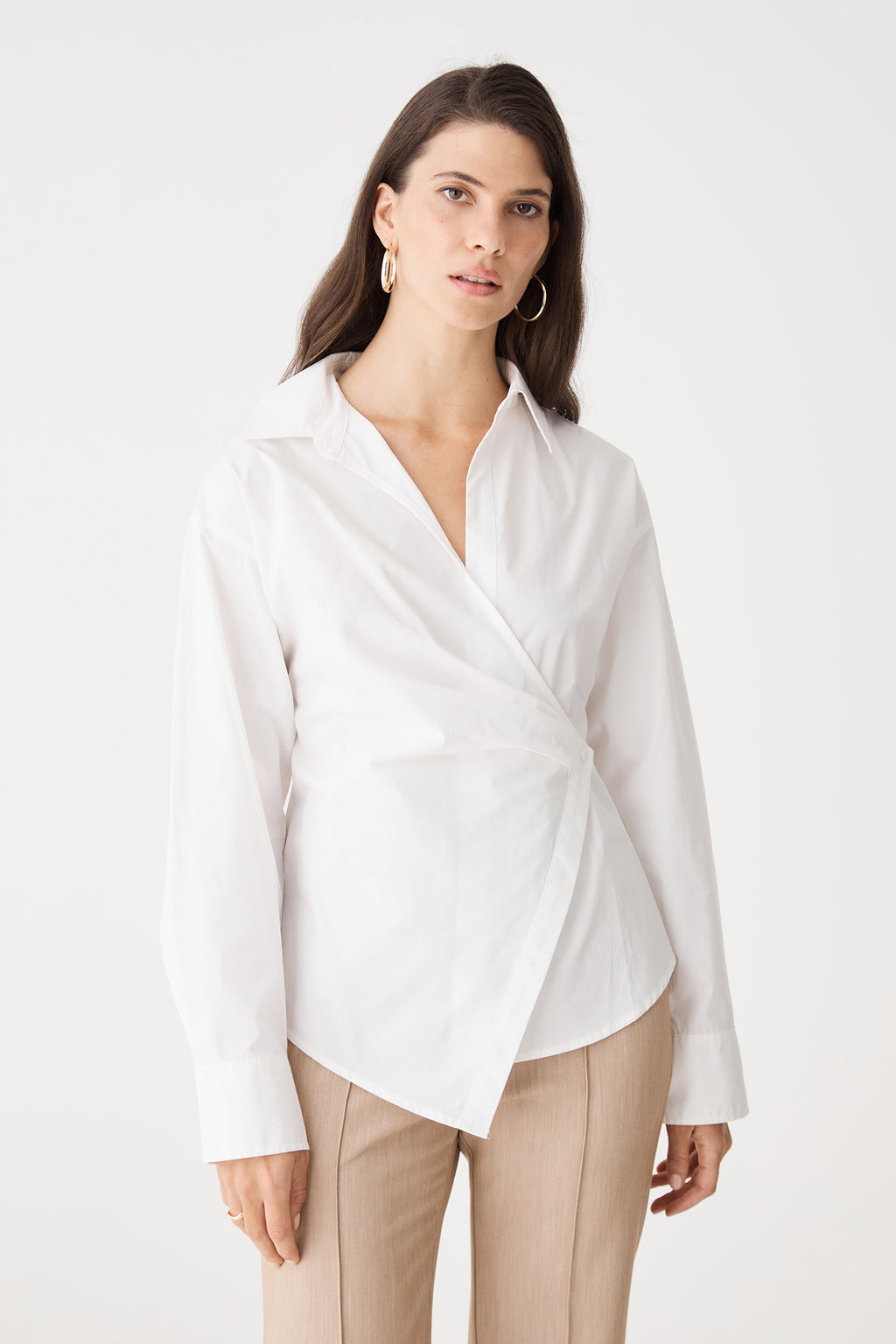 Close-up of the wrap front and long sleeves with button cuffs in ivory