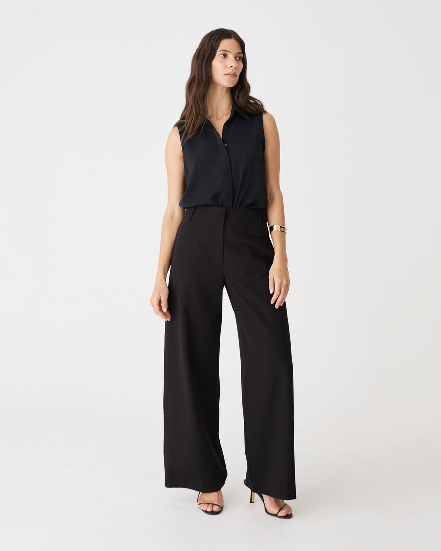 Brooklyn Sleeveless Shirt in black, front view worn with black wide-leg trousers