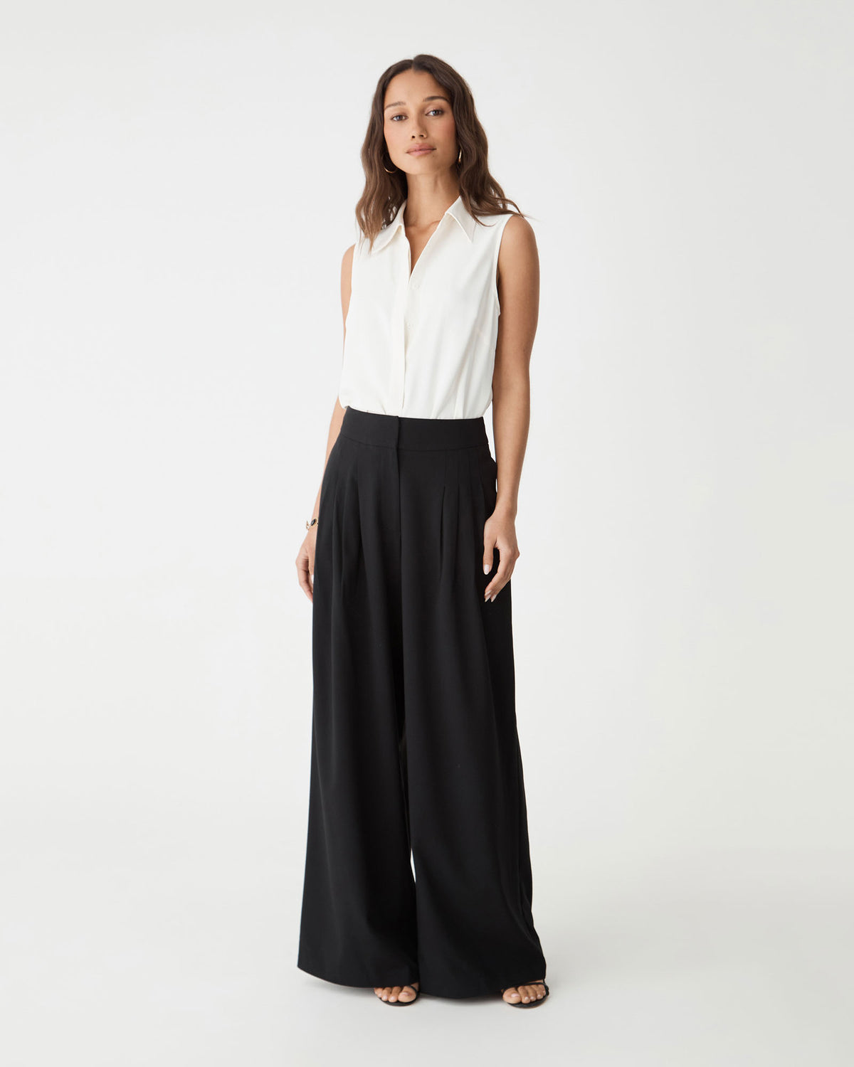 Brooklyn Sleeveless Shirt in ivory, front view worn with black wide-leg trousers