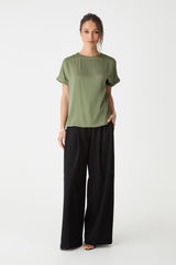 Cameron Satin Tee in soft khaki, front view worn with black wide-leg trousers