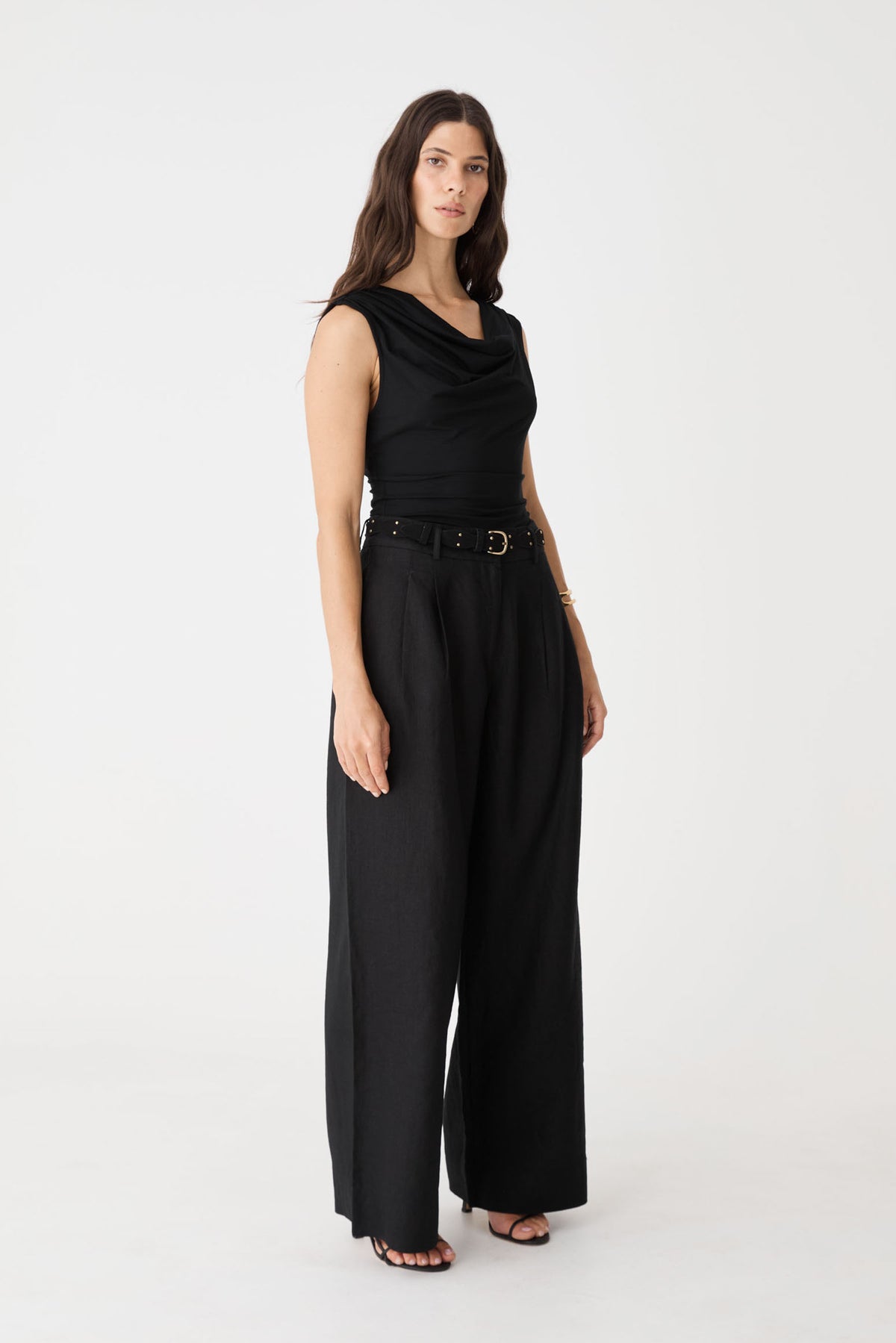 Side view of the black sleeveless cowl top and wide-leg trousers