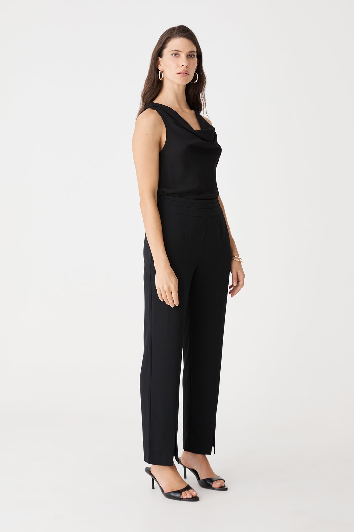 Side view of the black sleeveless top with black trousers