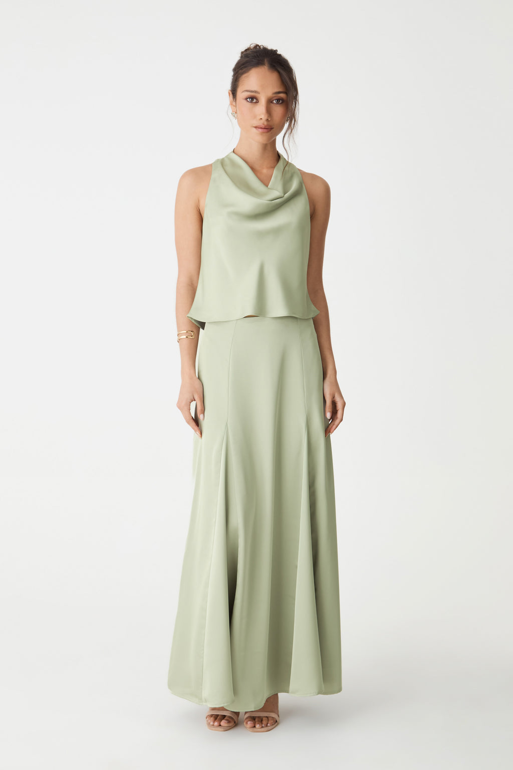 Front view of Freya Satin Cowl Top in pistachio, sleeveless with cowl neck, worn with matching long skirt