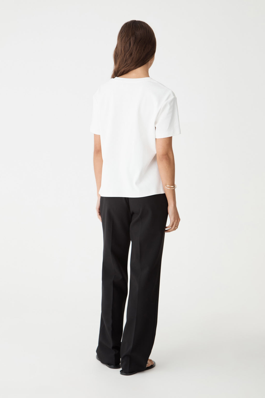 Back view of the white May V-Neck Cotton T-Shirt with black trousers