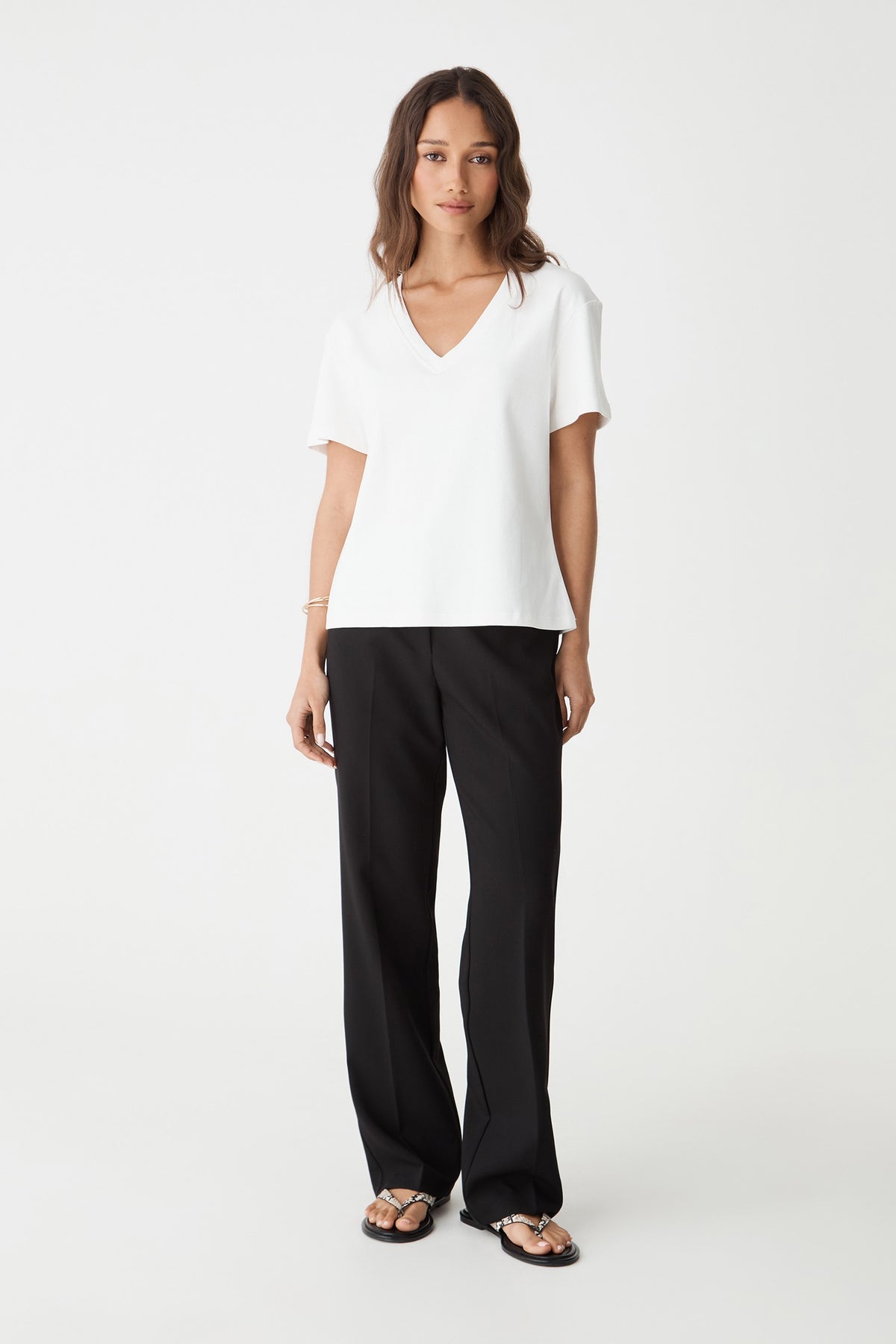 May V-Neck Cotton T-Shirt in white, front view worn with black wide-leg trousers