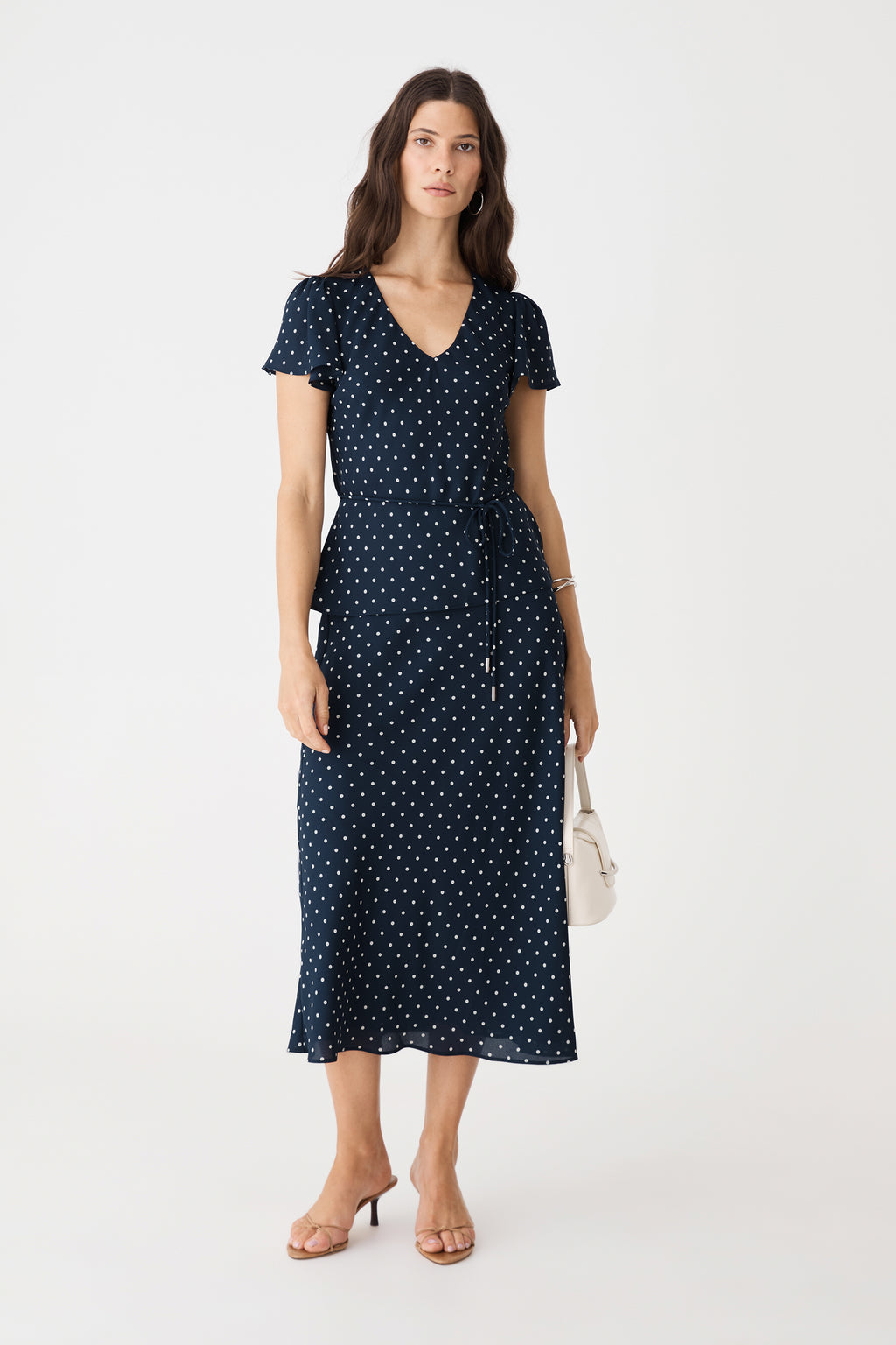 Danielle Frill Sleeve Top in Navy Spot, front view worn with matching polka dot midi skirt and tie belt