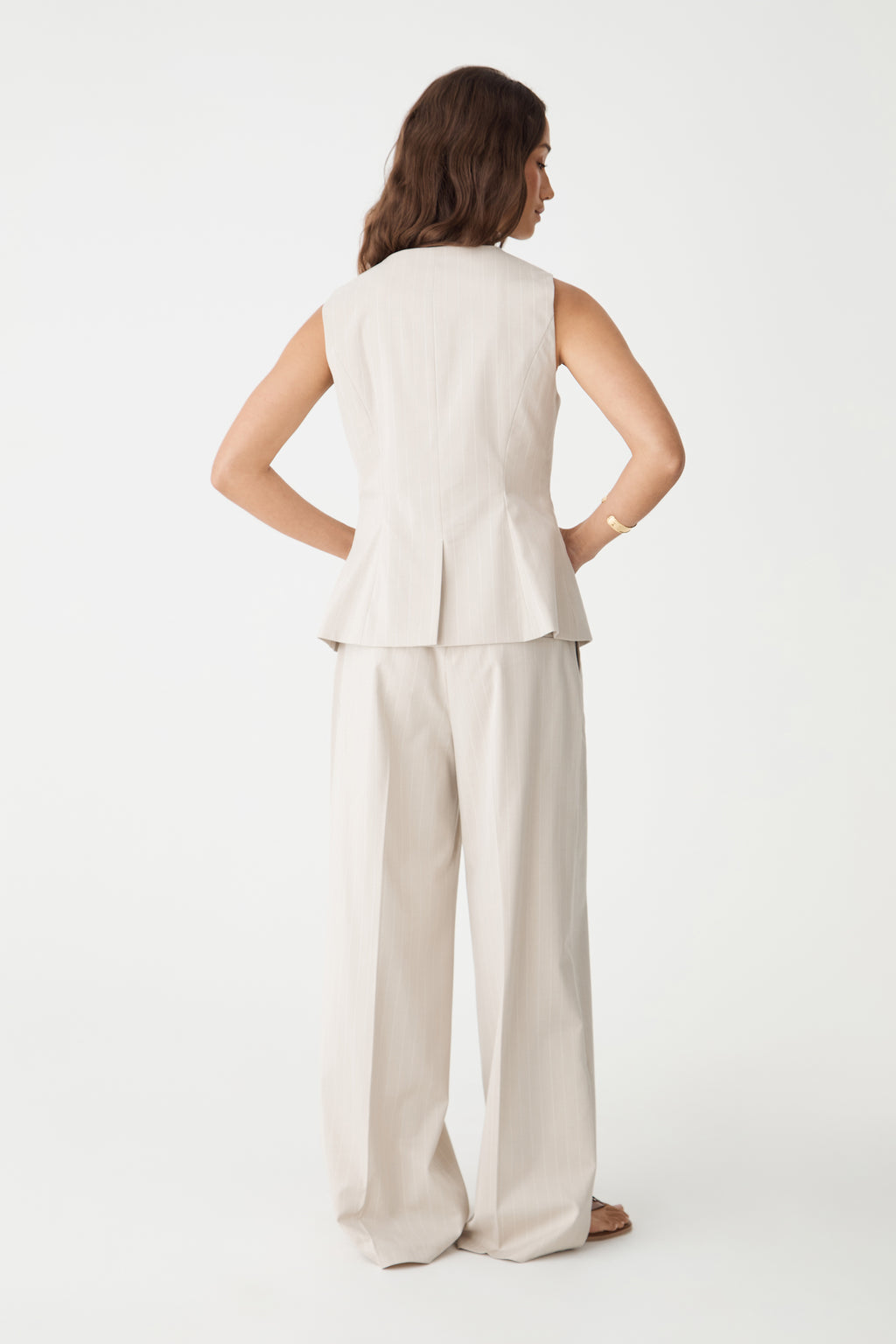 Back view of the beige pinstripe vest, close-up of the fitted waist