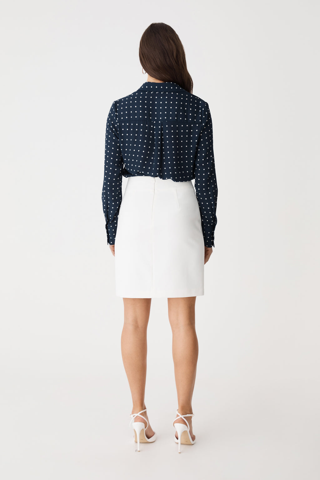Back view of the Danielle Spot Shirt in Navy Spot with a white skirt