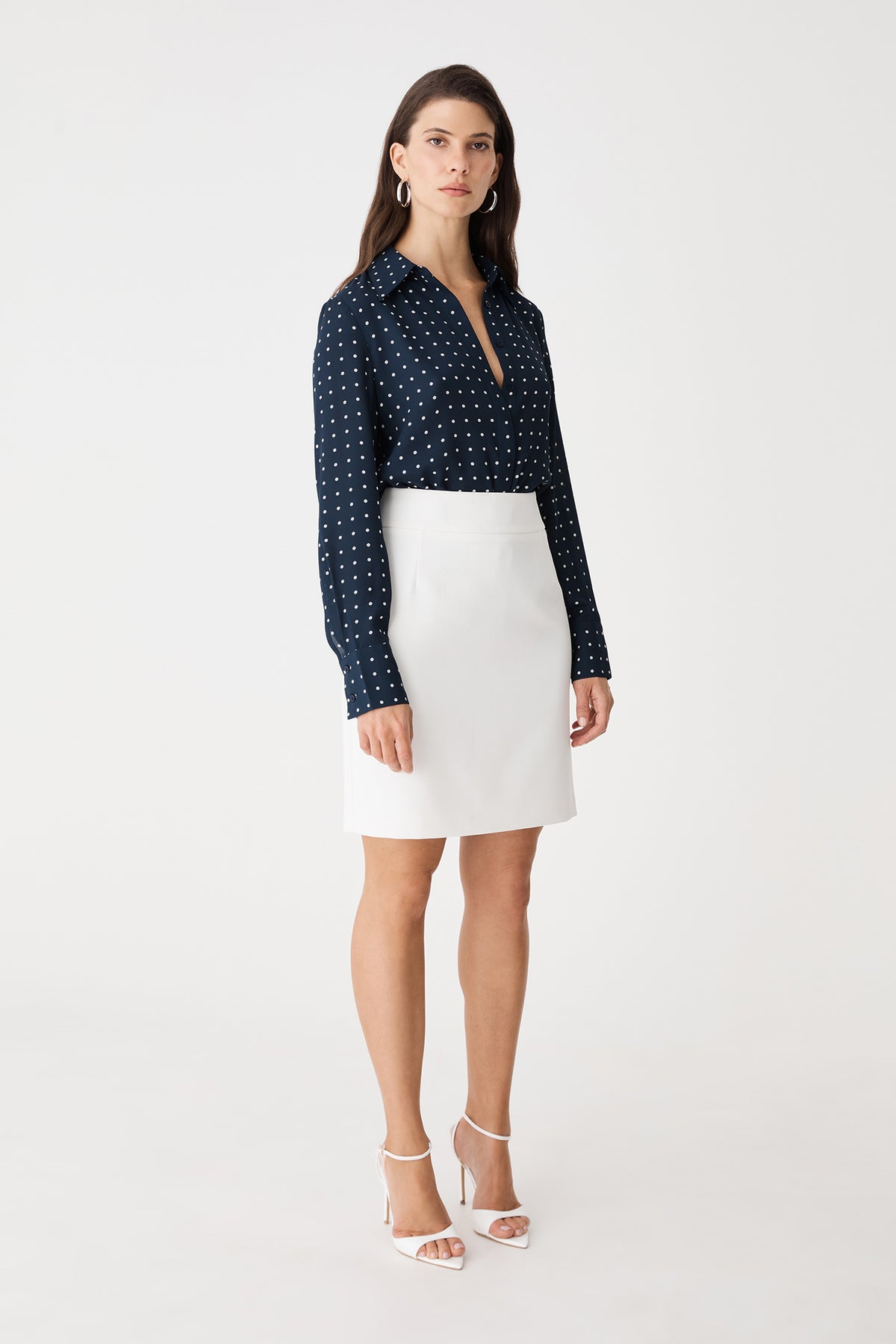 Side view of the Danielle Spot Shirt in Navy Spot with a white skirt