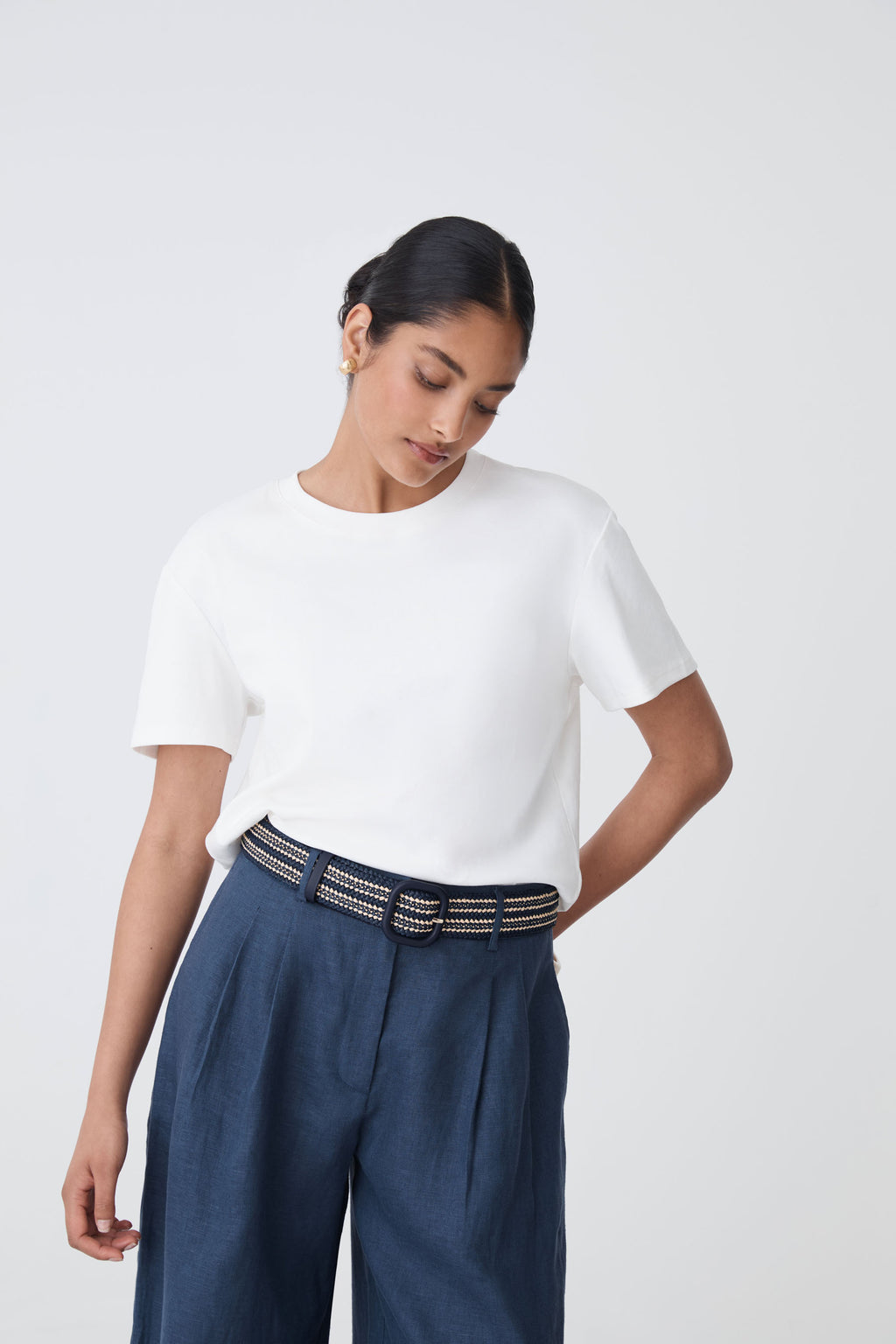 Maya Braid Belt in black and cream worn with white tee and navy trousers, front view