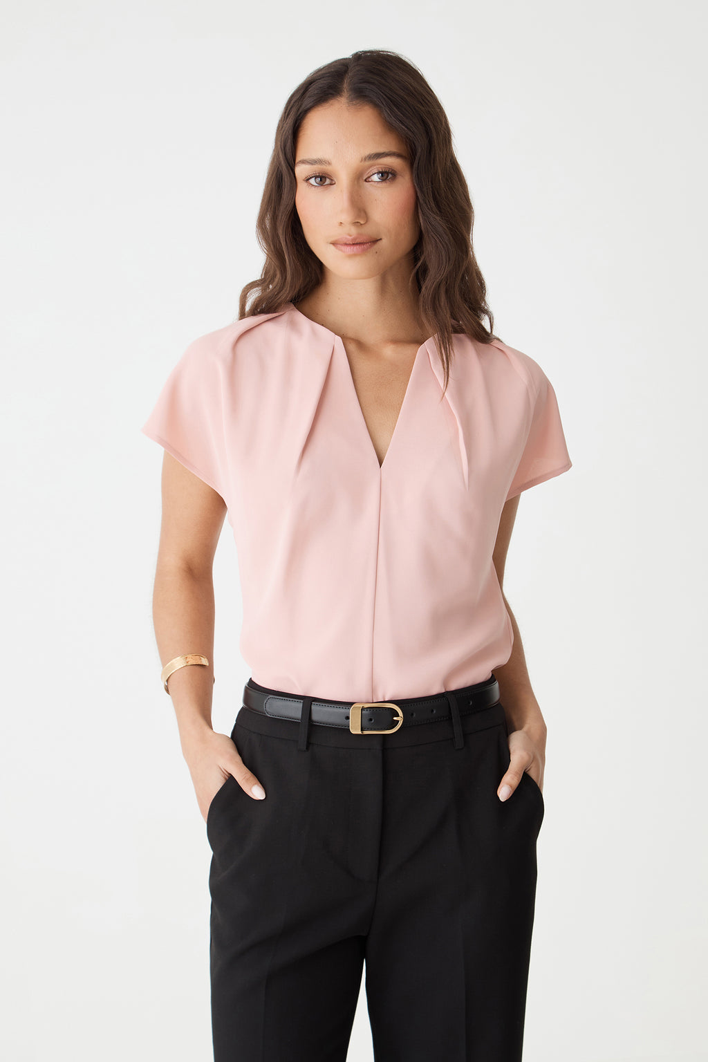 Rue Leather Belt in black worn with a pink short-sleeve top and black trousers, front view