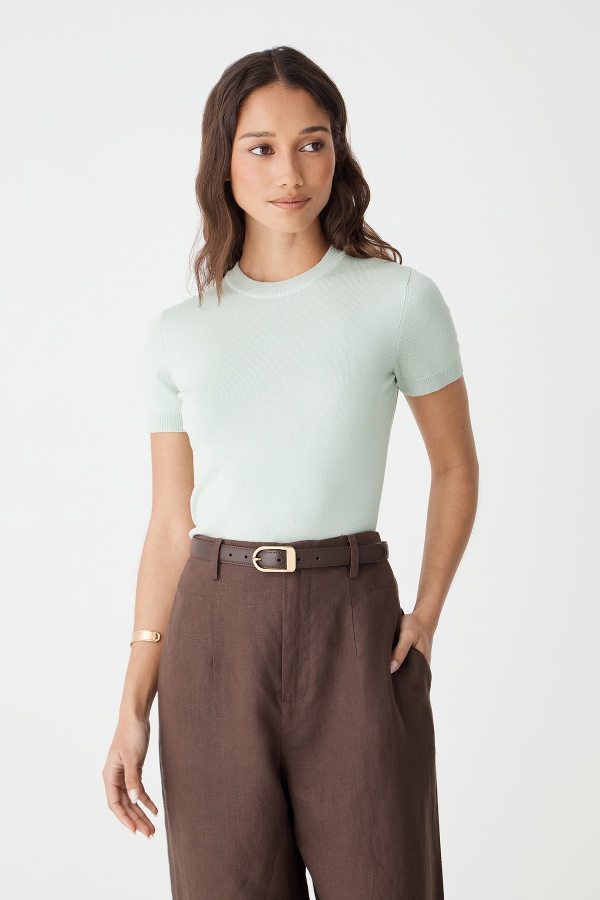Rue Leather Belt in dark brown worn with brown pants and a mint tee, front view