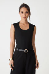 Aura Leather Belt in black worn at the waist with a sleeveless top, front view with gold-tone oval buckle