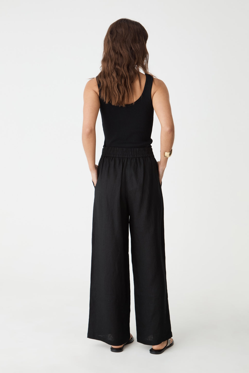 Back view showing the elasticated back waistband of the black linen pants